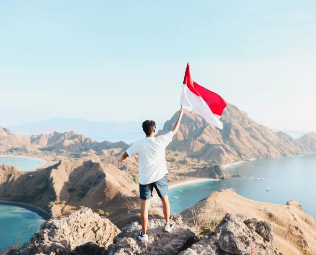 Indonesian flag over tropical mountains near Wakatobi